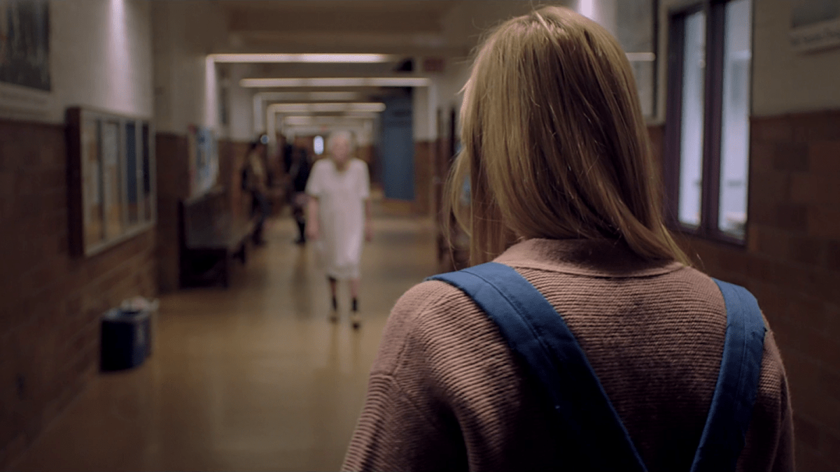 Woman walking down a corridor in the film It Follows