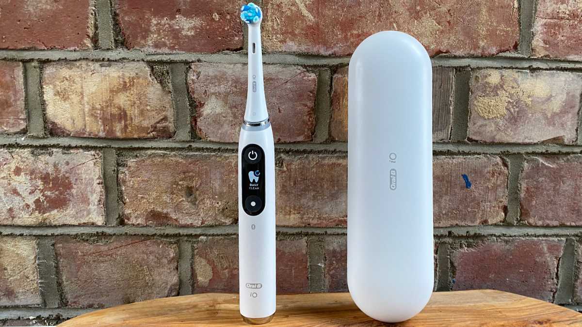 Electric toothbrush and case against a brick wall