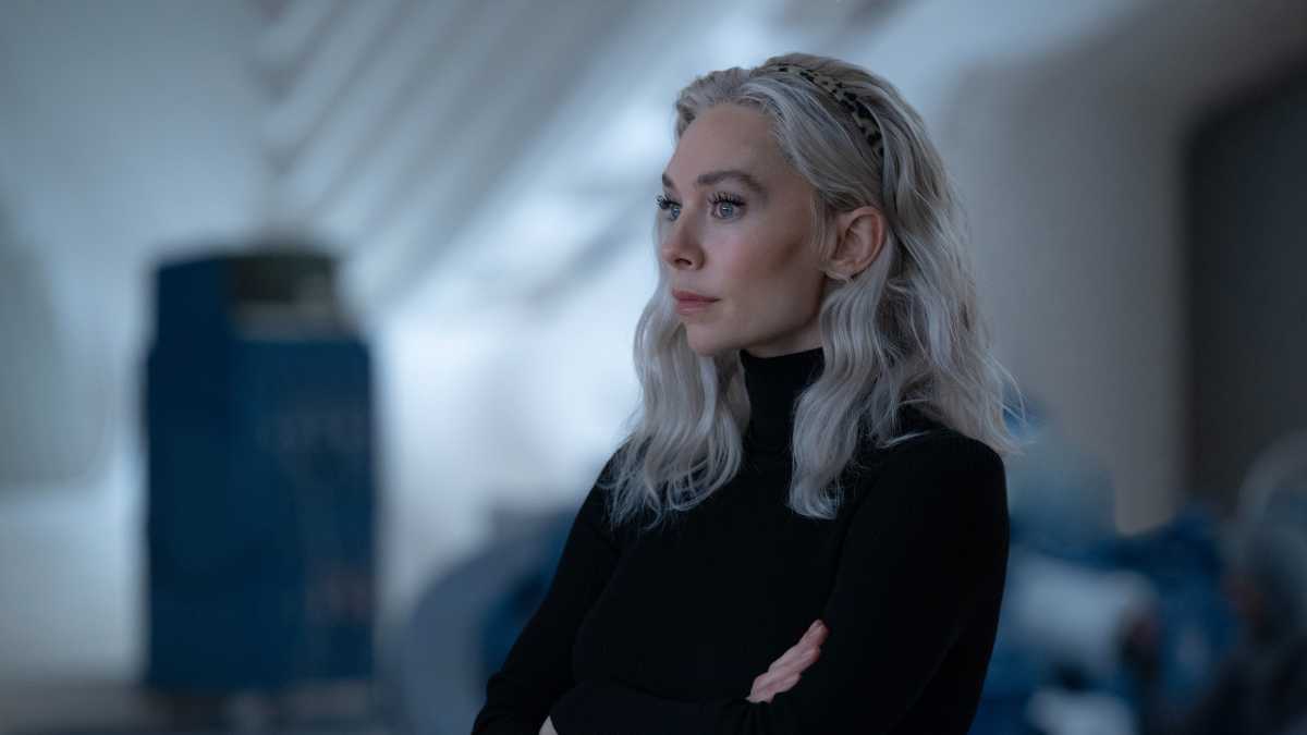 Vanessa Kirby as Sue Storm standing with her arms folded.