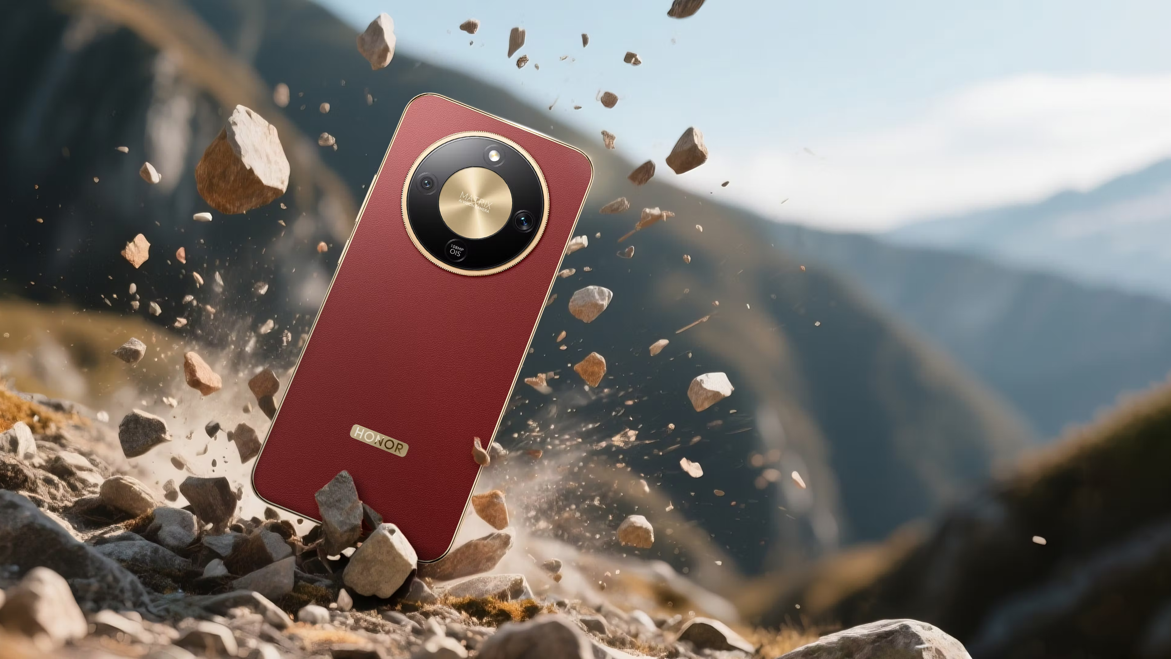Honor Magic8 Lite/X9d caindo sobre pedregulhos, com montanhas ao fundo