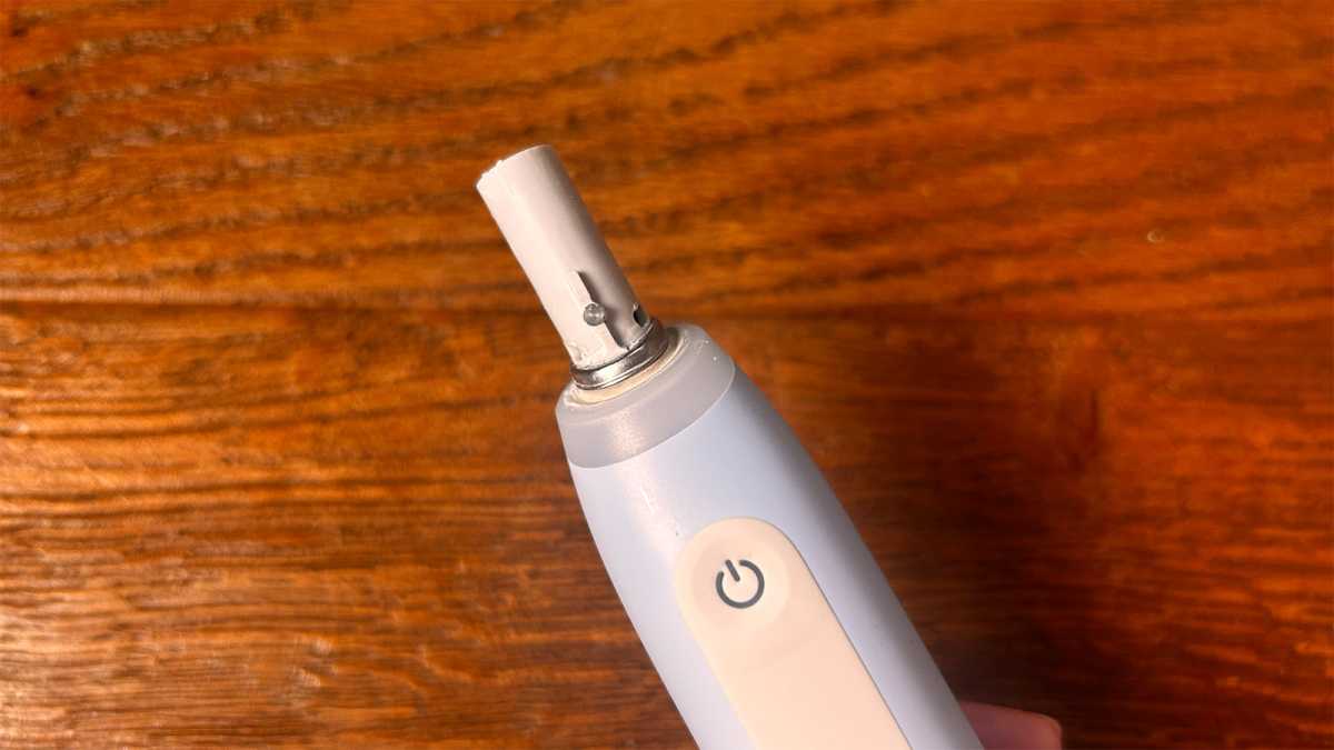 A close-up of the metal ring at the top of the brush handle