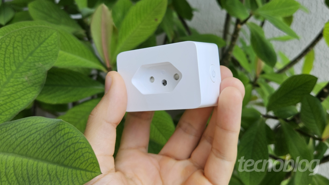 imagem de uma m&atilde;o segurando uma tomada inteligente TP-Link Tapo P110