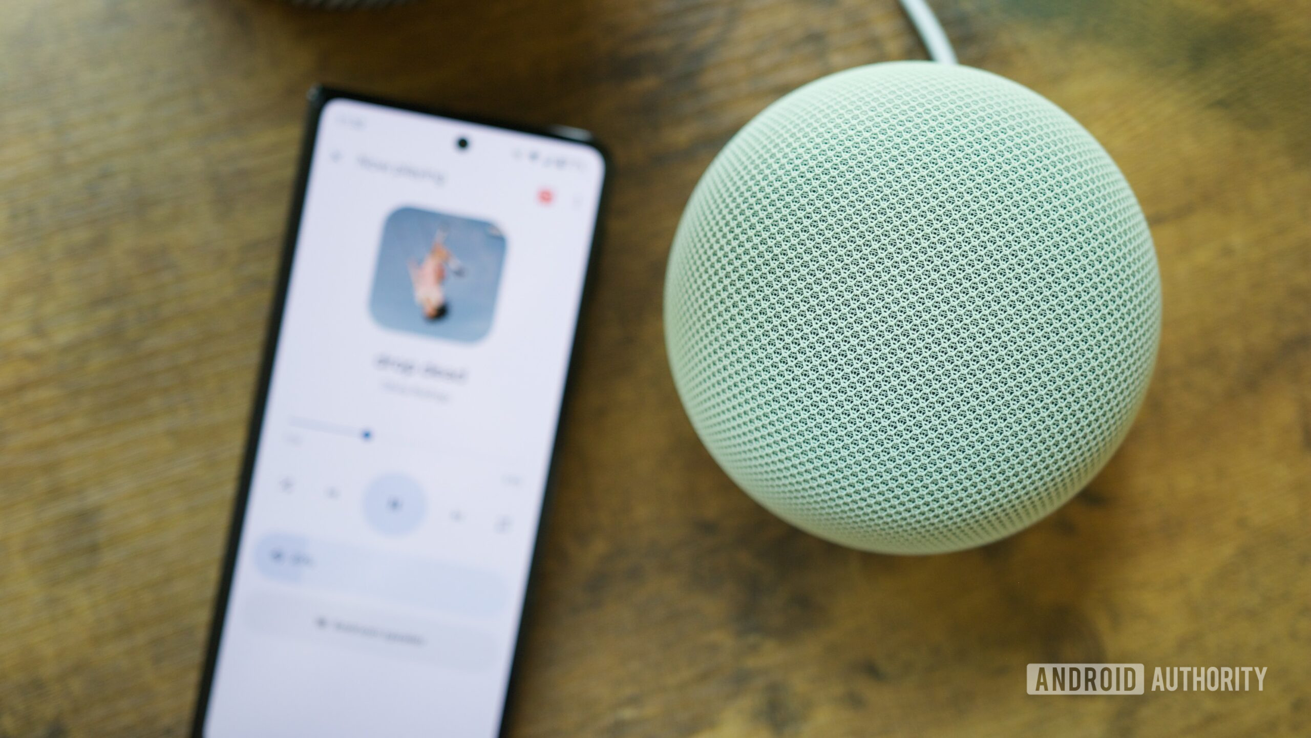 análise do alto-falante doméstico do Google 8 Alto-falante Google Home próximo a um telefone Android executando o app Google Home.